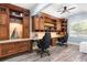Home office featuring custom wood built-ins with granite countertops and stylish decor at 209 Hearthstone Reach, Peachtree City, GA 30269