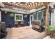 Outdoor kitchen featuring brick flooring, pergola, grill, and outdoor dining seating at 209 Hearthstone Reach, Peachtree City, GA 30269