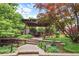 Landscaped backyard features a pergola with outdoor dining and entertaining space at 209 Hearthstone Reach, Peachtree City, GA 30269