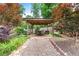 Covered outdoor seating area and landscaped backyard for entertaining at 209 Hearthstone Reach, Peachtree City, GA 30269