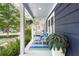 Charming porch with comfortable seating, a decorative rug, and lush greenery creating an inviting outdoor retreat at 209 Hearthstone Reach, Peachtree City, GA 30269