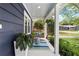 Cozy porch featuring a charming swing, colorful rug, and lush potted plants creating a relaxing outdoor space at 209 Hearthstone Reach, Peachtree City, GA 30269