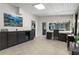 Bright sunroom with tile flooring, large picture window with view of landscaped yard, and custom cabinets at 209 Hearthstone Reach, Peachtree City, GA 30269