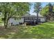 View of the backyard showcasing a wooden deck, brick facade and green space, ideal for relaxation and outdoor activities at 5421 Brownlee Rd, Stone Mountain, GA 30087