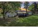 View of the backyard showcasing a wooden deck, brick facade and green space, ideal for relaxation and outdoor activities at 5421 Brownlee Rd, Stone Mountain, GA 30087