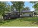 Spacious backyard features a large deck, mature trees, and lush green lawn, perfect for outdoor entertaining at 5421 Brownlee Rd, Stone Mountain, GA 30087