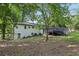 Expansive backyard featuring a large deck with steps, mature trees, and ample space for recreation at 5421 Brownlee Rd, Stone Mountain, GA 30087