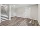 Finished basement with neutral paint, a staircase, an exterior door, and wood-look floors at 5421 Brownlee Rd, Stone Mountain, GA 30087