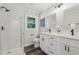 Bright bathroom with a glass-enclosed shower and double vanity with modern fixtures at 5421 Brownlee Rd, Stone Mountain, GA 30087