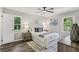 Cozy bedroom with natural light, hardwood floors, and a ceiling fan at 5421 Brownlee Rd, Stone Mountain, GA 30087