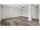 Large room with wood-look floors, white trim, a ceiling fan, and lots of space at 5421 Brownlee Rd, Stone Mountain, GA 30087