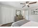 A spacious bedroom featuring hardwood floors, ceiling fan, and closet at 5421 Brownlee Rd, Stone Mountain, GA 30087