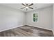 A spacious bedroom featuring hardwood floors, ceiling fan, and natural light at 5421 Brownlee Rd, Stone Mountain, GA 30087