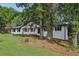 Charming renovated white brick home with manicured lawn and mature trees in a private, wooded setting at 5421 Brownlee Rd, Stone Mountain, GA 30087