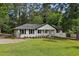 Beautifully renovated home featuring a manicured front yard, and a classic white brick exterior at 5421 Brownlee Rd, Stone Mountain, GA 30087