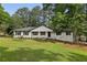 Charming one story home featuring a manicured front yard and a classic white painted brick exterior at 5421 Brownlee Rd, Stone Mountain, GA 30087