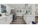 Modern kitchen with white cabinets, stainless steel appliances, and hardwood floors at 5421 Brownlee Rd, Stone Mountain, GA 30087