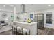 Modern kitchen with stainless steel appliances, a breakfast bar, and open access to the living area at 5421 Brownlee Rd, Stone Mountain, GA 30087