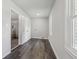 Large laundry room with neutral paint, wood-look floors, and a window at 5421 Brownlee Rd, Stone Mountain, GA 30087