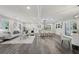 Spacious open-concept living room features luxury vinyl plank flooring, a combined kitchen and dining area, and modern finishes at 5421 Brownlee Rd, Stone Mountain, GA 30087