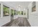 Screened-in sunroom with a view of the backyard and wood-look floors at 5421 Brownlee Rd, Stone Mountain, GA 30087