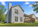 Backyard with wood deck, vinyl siding, and chimney at 9511 Rollinghills Dr, Jonesboro, GA 30238