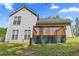 Home's backyard featuring a wooden deck, a lush lawn, and a peaceful outdoor space at 9511 Rollinghills Dr, Jonesboro, GA 30238