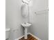 Simple powder room featuring a pedestal sink, tile floors, and modern fixtures at 9511 Rollinghills Dr, Jonesboro, GA 30238
