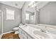 Bright bathroom boasts double sinks, wood-look floors, and neutral paint at 9511 Rollinghills Dr, Jonesboro, GA 30238