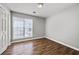 Comfortable bedroom featuring wood-look floors, a window, and ample natural light at 9511 Rollinghills Dr, Jonesboro, GA 30238