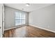Well-lit bedroom with wood-look floors and a double window at 9511 Rollinghills Dr, Jonesboro, GA 30238