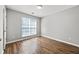 Bedroom with hardwood floors, a window for natural light and neutral paint at 9511 Rollinghills Dr, Jonesboro, GA 30238