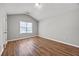 Cozy bedroom features wood-look floors and a large window at 9511 Rollinghills Dr, Jonesboro, GA 30238