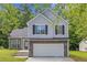 Beautiful home with a two-car garage, manicured lawn, and traditional design elements at 9511 Rollinghills Dr, Jonesboro, GA 30238