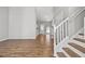 Bright living room with hardwood floors leading to the stairs and kitchen at 9511 Rollinghills Dr, Jonesboro, GA 30238