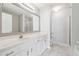 Bright bathroom featuring a large vanity sink, a mirror and new hardware at 1363 Penhurst Dr, Lawrenceville, GA 30043