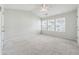 Spacious bedroom with a ceiling fan and multiple windows allowing natural light at 1363 Penhurst Dr, Lawrenceville, GA 30043