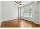 Bright bedroom with hardwood floors, ceiling fan, and large windows for natural light at 1363 Penhurst Dr, Lawrenceville, GA 30043
