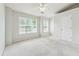 Bright bedroom features carpet floors, windows and ceiling fan at 1363 Penhurst Dr, Lawrenceville, GA 30043