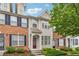 Charming townhome boasts brick accents, tidy landscaping, and inviting curb appeal at 1363 Penhurst Dr, Lawrenceville, GA 30043