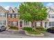 Inviting townhome featuring brick accents, manicured landscaping, and convenient parking at 1363 Penhurst Dr, Lawrenceville, GA 30043