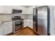 Modern kitchen features stainless appliances and stylish backsplash, optimizing functionality at 1363 Penhurst Dr, Lawrenceville, GA 30043