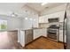 Open kitchen blends seamlessly with the living area, featuring stainless appliances and natural light at 1363 Penhurst Dr, Lawrenceville, GA 30043