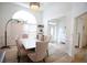 Elegant dining room with modern lighting, wainscoting, and an arch window at 260 Ruby Forest Pkwy, Suwanee, GA 30024