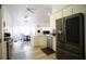 Bright kitchen with stainless steel appliances, white cabinets, and an open layout to dining area at 260 Ruby Forest Pkwy, Suwanee, GA 30024