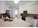 Modern kitchen with stainless steel appliances, granite countertops, and stylish backsplash at 260 Ruby Forest Pkwy, Suwanee, GA 30024