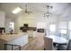 Open kitchen with island, stainless appliances, and hardwood flooring seamlessly connected to dining at 260 Ruby Forest Pkwy, Suwanee, GA 30024