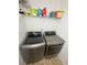 Modern laundry room featuring a large washer and dryer at 260 Ruby Forest Pkwy, Suwanee, GA 30024