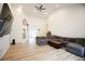 Spacious living room with vaulted ceilings, hardwood floors, and a large gray sectional couch at 260 Ruby Forest Pkwy, Suwanee, GA 30024