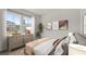 Bright bedroom showcasing a large window, a dresser with decor, and modern art pieces at 3178 Birdsong Ave, Covington, GA 30016